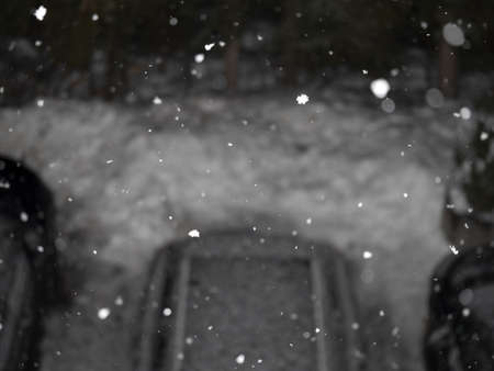 snow falling snowing at night in dolomites mountains car parkの写真素材