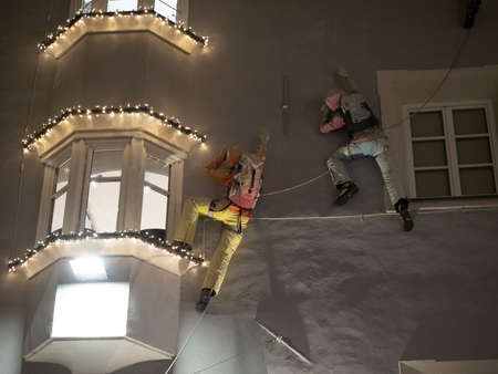 climber on a building climbing at night in brunico