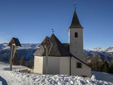 church on Monte croce dolomites badia valley mountains in winter snow panorama from armentara