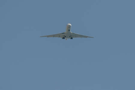 airplane jet while landing from bottom viewの写真素材