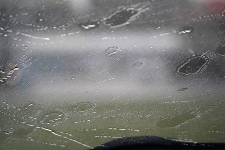 heavy rain on car windscreen wiper detailの写真素材