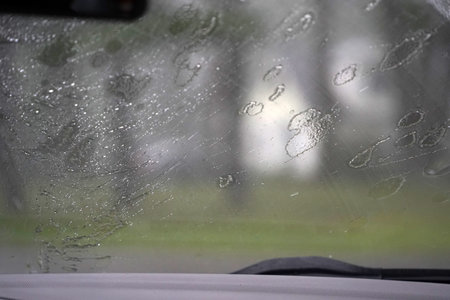 heavy rain on car windscreen wiper detailの写真素材