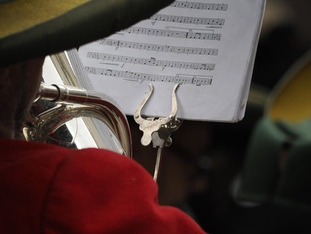 hands playing bass tuba detail in a bandの写真素材