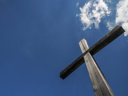 wooden cross on blue sky background sunlightの写真素材