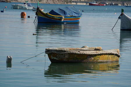 malta colorful painted fishing boat in marsaxlokk harborの写真素材