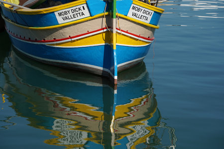 malta colorful painted fishing boat in marsaxlokk harborの写真素材
