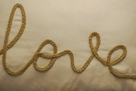 gold Love typo knitting on the textile love word embroidery