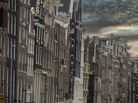 amsterdam old houses view from canals at sunsetの写真素材