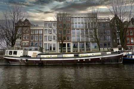 amsterdam old houses view from canals at sunsetの写真素材
