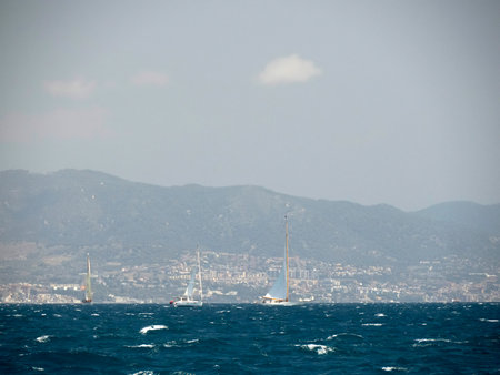 A strong wind regatta in barcelona Sailing ship in a strong wind. Yachtingの写真素材