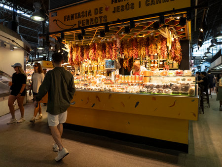 BARCELONA, SPAIN - JULY 13 2023: boqueria the barcelona fruit seafood meat ham food market FULL OF CUSTOMERSのeditorial素材