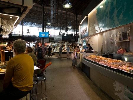 BARCELONA, SPAIN - JULY 13 2023: boqueria the barcelona fruit seafood meat ham food market FULL OF CUSTOMERSのeditorial素材