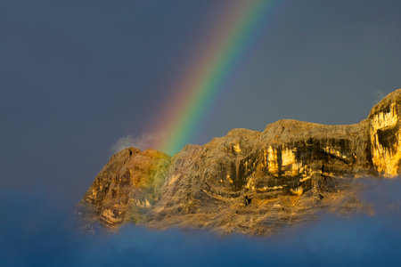 A Superb rainbow on cross mountain Monte croce Dolomites Alps near Alta Badia, Trentino-Alto-Adige region, Italy. Summer season.の写真素材