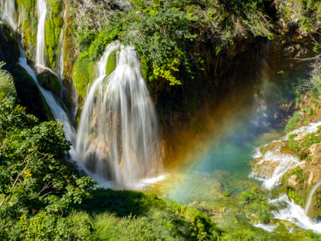 A Summer view of water lakes and beautiful waterfalls in Plitvice Lakes National Park, Croatia rainbow coming from splashes and drops.の写真素材