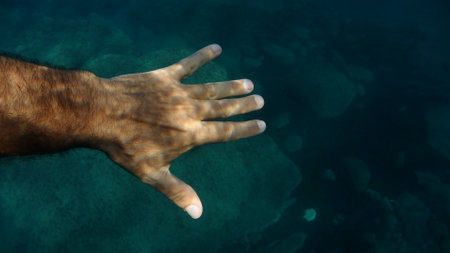 open palm human hand underwater detail close upの写真素材