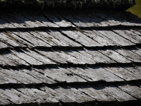An Old wooden shingles on a hut roof mountain wooden hut roof detailの写真素材