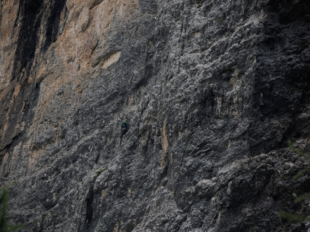 climbers climbing the rocks of the monte croce cross mountain in dolomites badia valley panorama landscapeの写真素材