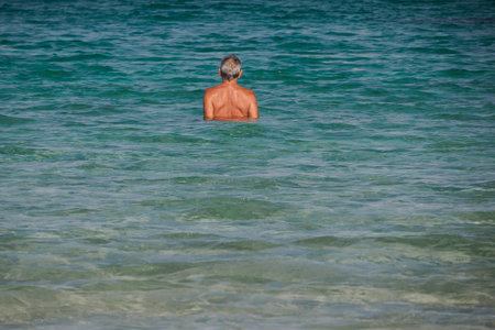 old man swimming in porquerolles island france, panorama landscapeの写真素材