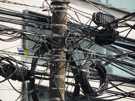 Mexico City, Messed up power lines and connection cables. Many tangled wires on electric poles in the cityの写真素材