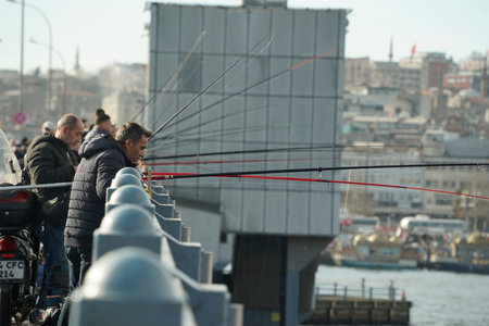 ISTANBUL, TURKEY - JANUARY 5 2024 People fishing on Galata Bridge. many people with fishing rod.のeditorial素材
