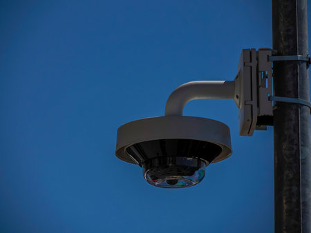 A 360 security camera isolated on blue sky background