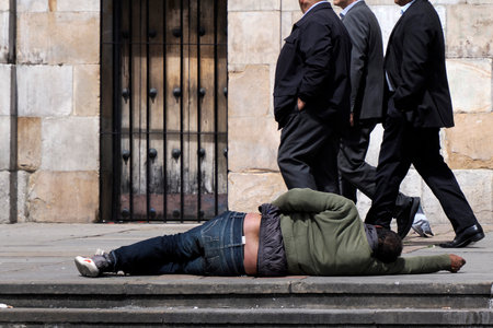 BOGOTA, COLOMBIA - JULY 3 2024 - A Drunk man ignored in front of the church of Plaza de Bolivarのeditorial素材