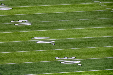 An American football field detail of white chalk drawn lines. 50 and 40 and 30 yards lineの写真素材