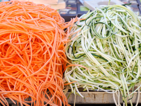 Orange Raw carrot and green zucchini spaghetti noodles detailの写真素材