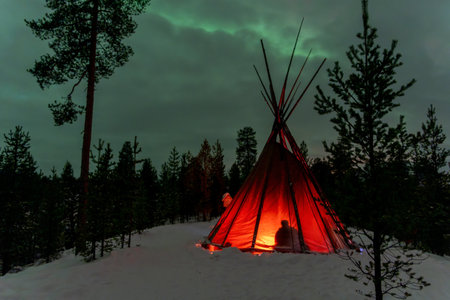 Sami tent with Northern Lights in Lapland Inari Nellin Lake forestの写真素材