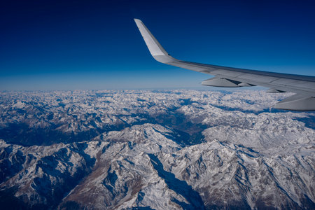 Alps aerial view from airplane cabin windowの写真素材