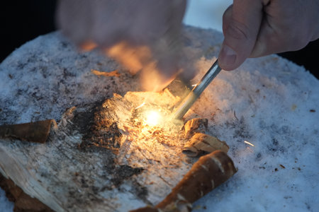 light the fire with the steel firesteel sparkles in lapland in winter detailの写真素材