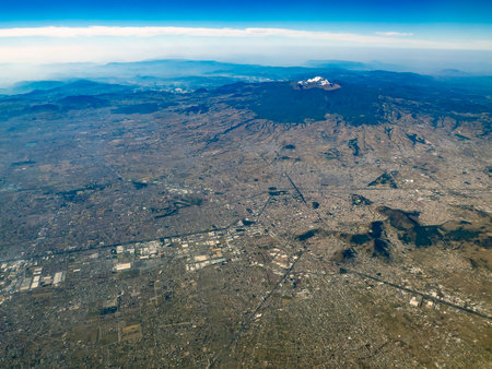 The Xico volcano and Mexico City aerial view while eruptingの写真素材