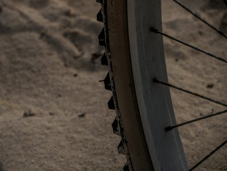 A bicycle tire detail on sand backgroundの写真素材