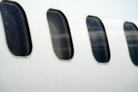 jet airplane detail of cabin windows and fuselageの写真素材