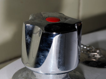 A red hot water old chromed faucet on ceramic washbasinの写真素材
