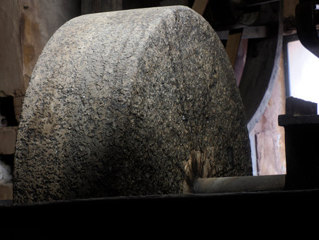 Detail of Old oil windmill stone in rousillon provence medieval village view