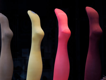 4 female colorful stockings isolated on blackの写真素材