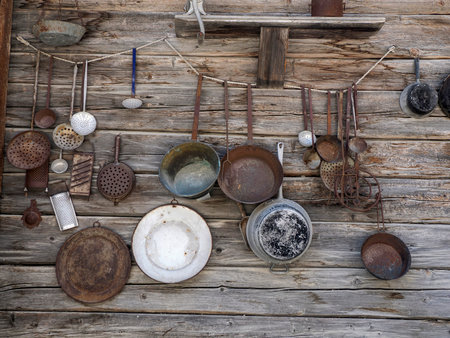 Some old tools on wooden cabin wall