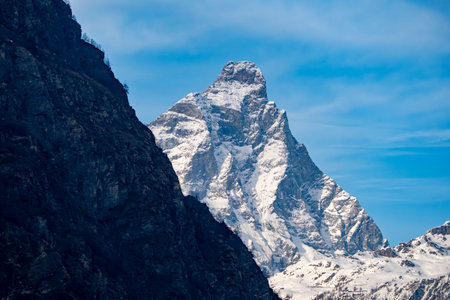 Iconic Matterhorn peak in the Swiss Alps, a majestic snow-capped mountain against a blue skyの写真素材