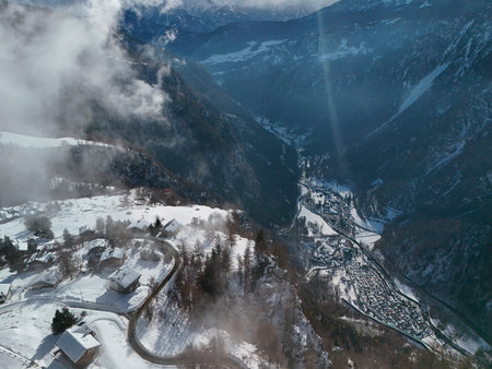 clouds coming in The Chamois alpine village aerial view in winter seasonの写真素材