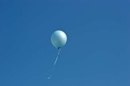 Blue balloon in the blue skyの写真素材