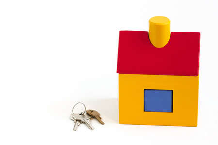 Toy house and keys over white backgroundの写真素材