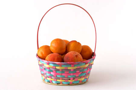 Basket with apricots and peachesの写真素材