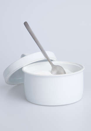 White sugar container with silver spoonの写真素材
