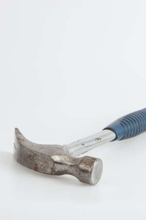 Old and rusty hammer with blue handleの写真素材