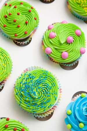 Colorful decorated cupcakes in a white boxの写真素材