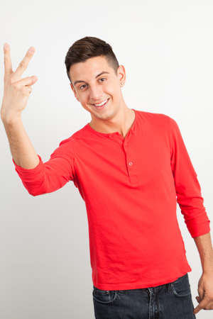 Young and handsome guy posing over white backgroundの写真素材