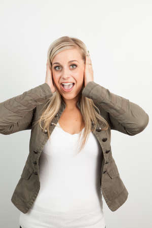 Young blond woman smiling against a white backgroundの写真素材