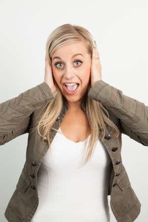 Young blond woman smiling against a white backgroundの写真素材