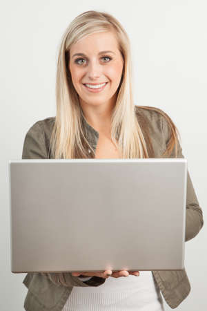 Young blond woman smiling against a white backgroundの写真素材